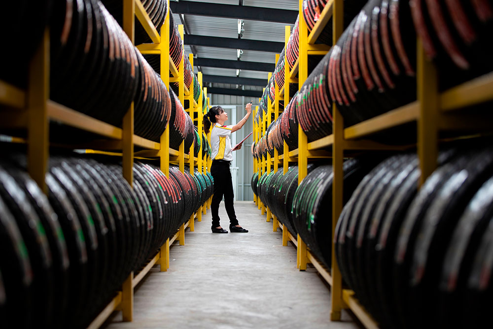 Woman Taking Inventory Of Tires Woman Taking Inventory Of Tires